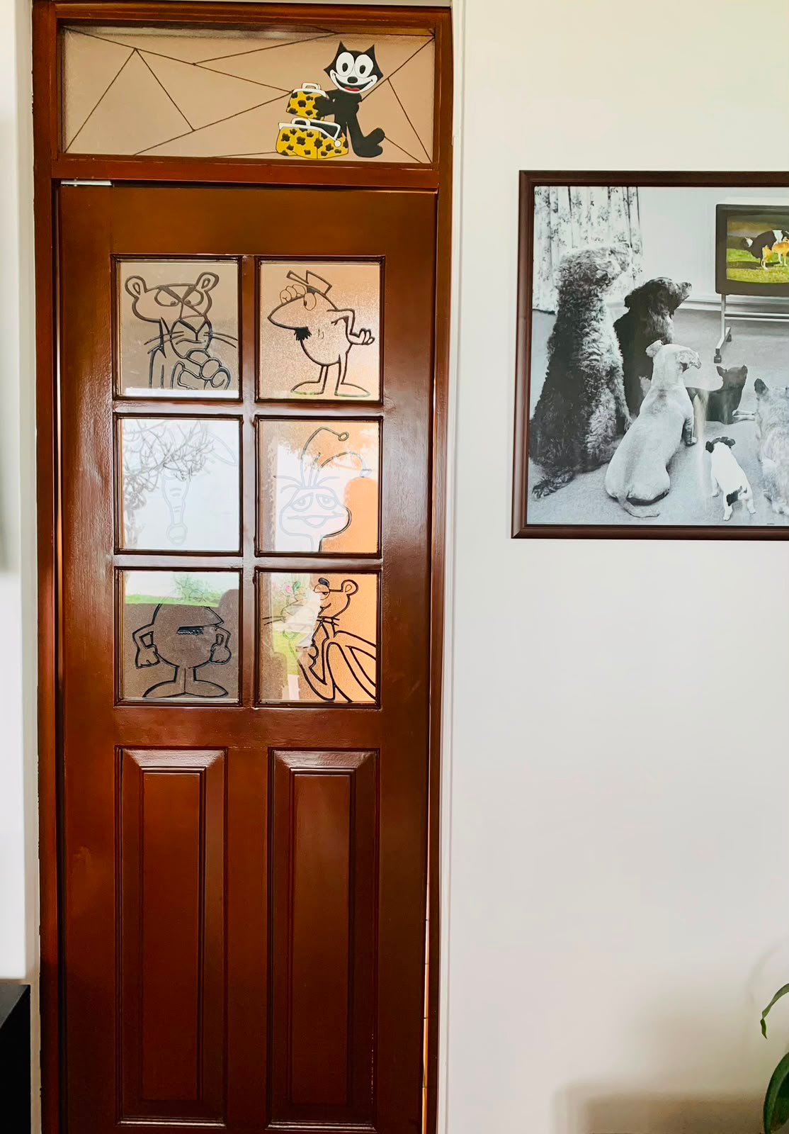 Vitral con personajes de caricatura en puerta